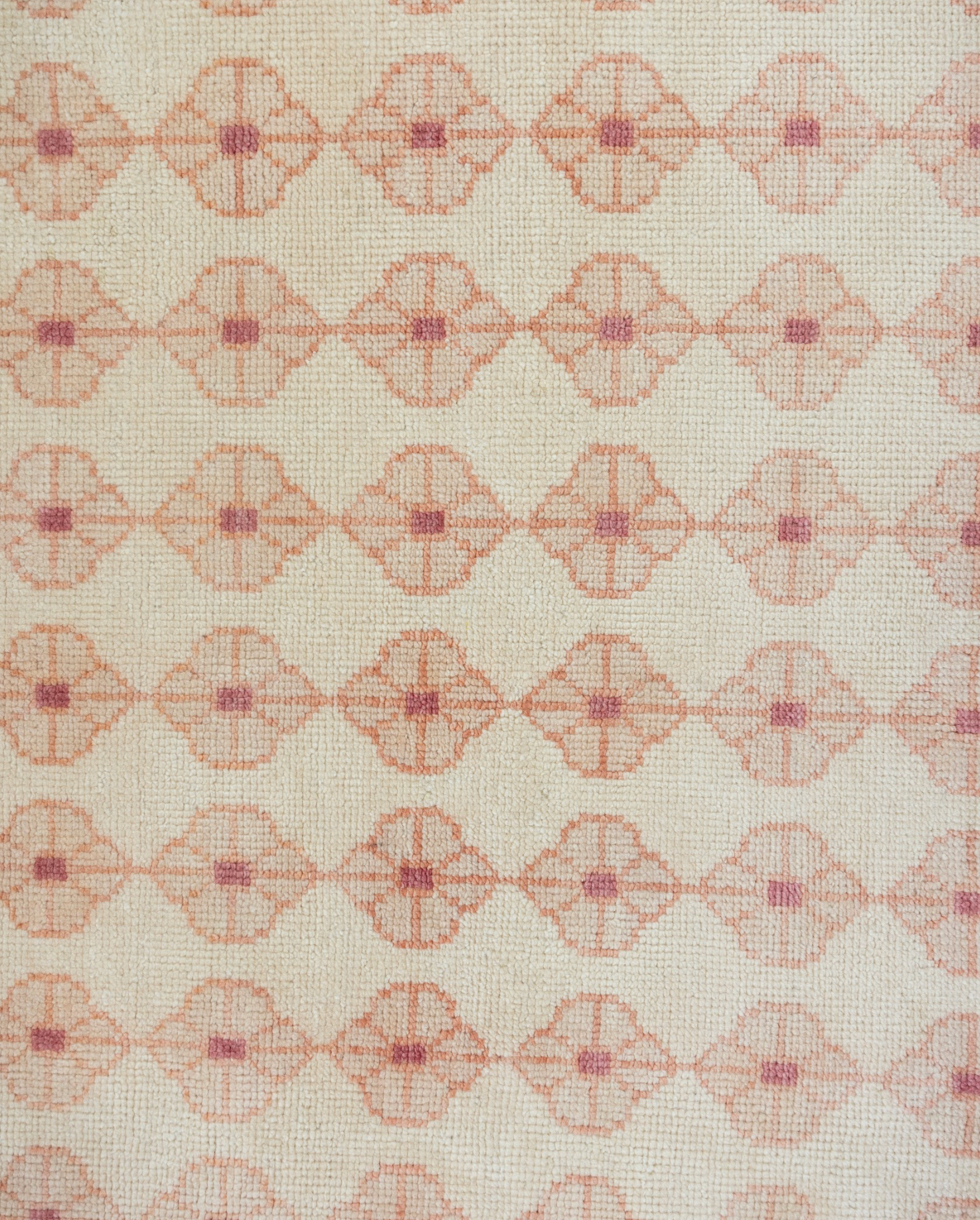 Patterned rug with geometric design on a beige background