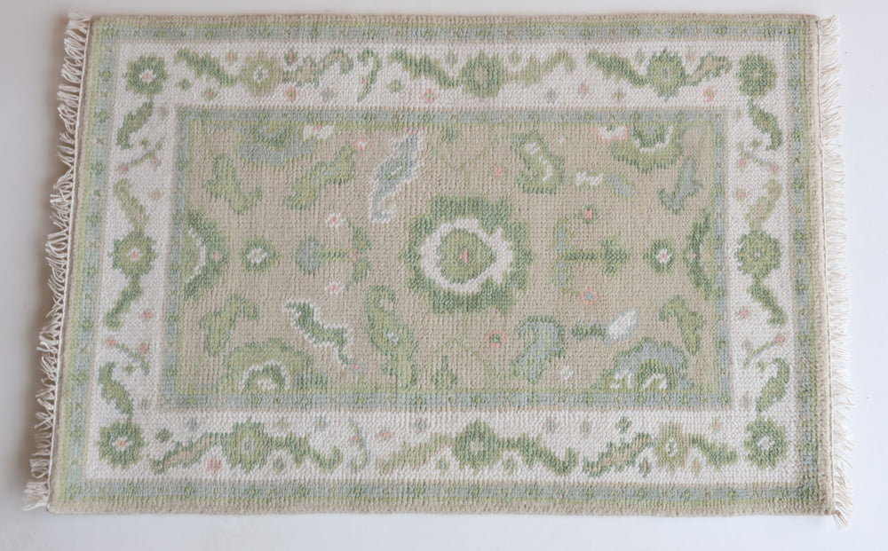 Hand-knotted wool rug with classic Oushak floral design in soft green, ivory, and blush – Ellis Mini Rug by Locust Lane Rugs