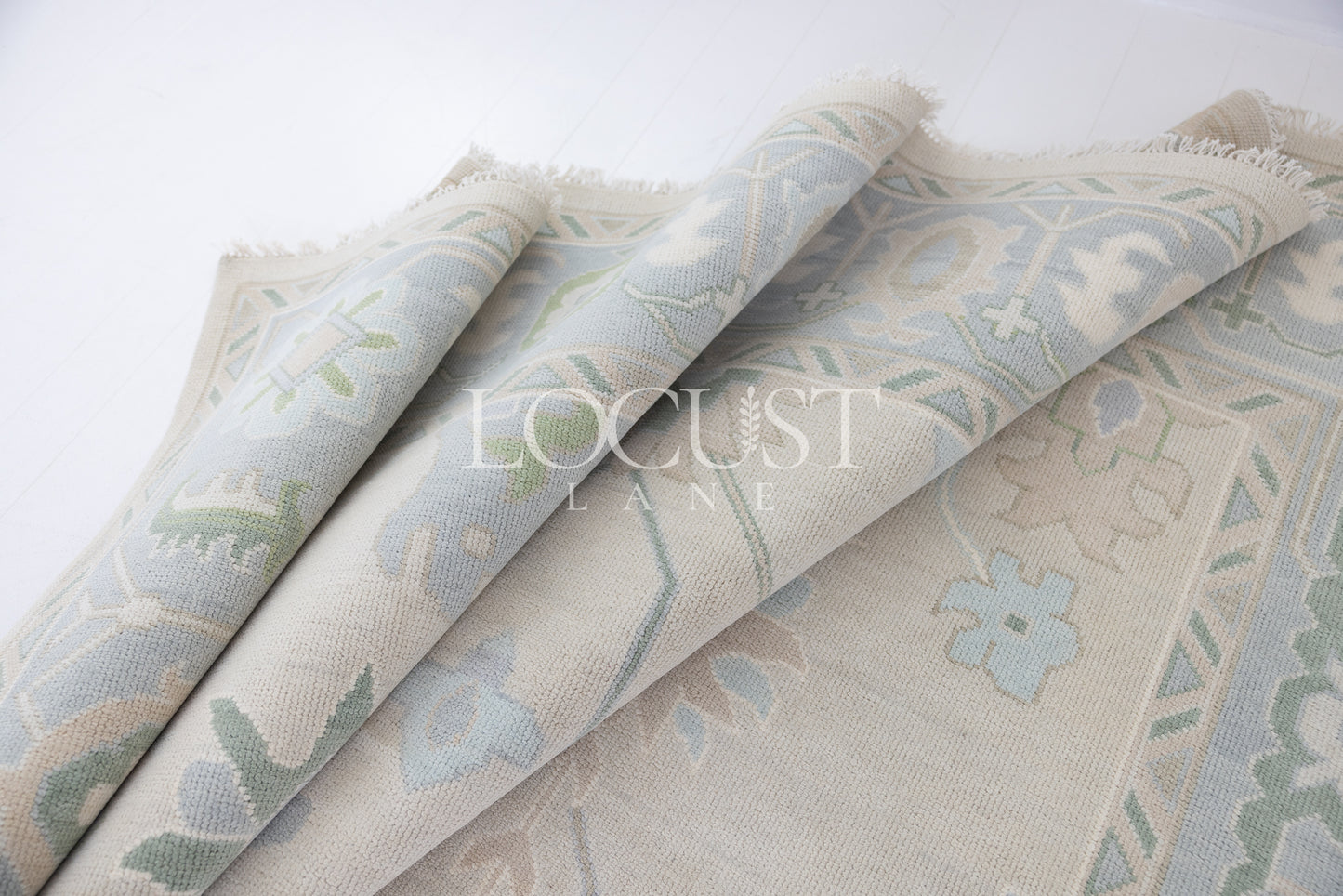 Fiona hand-knotted wool Oushak rug in ivory and faded blue from Locust Lane Rugs.