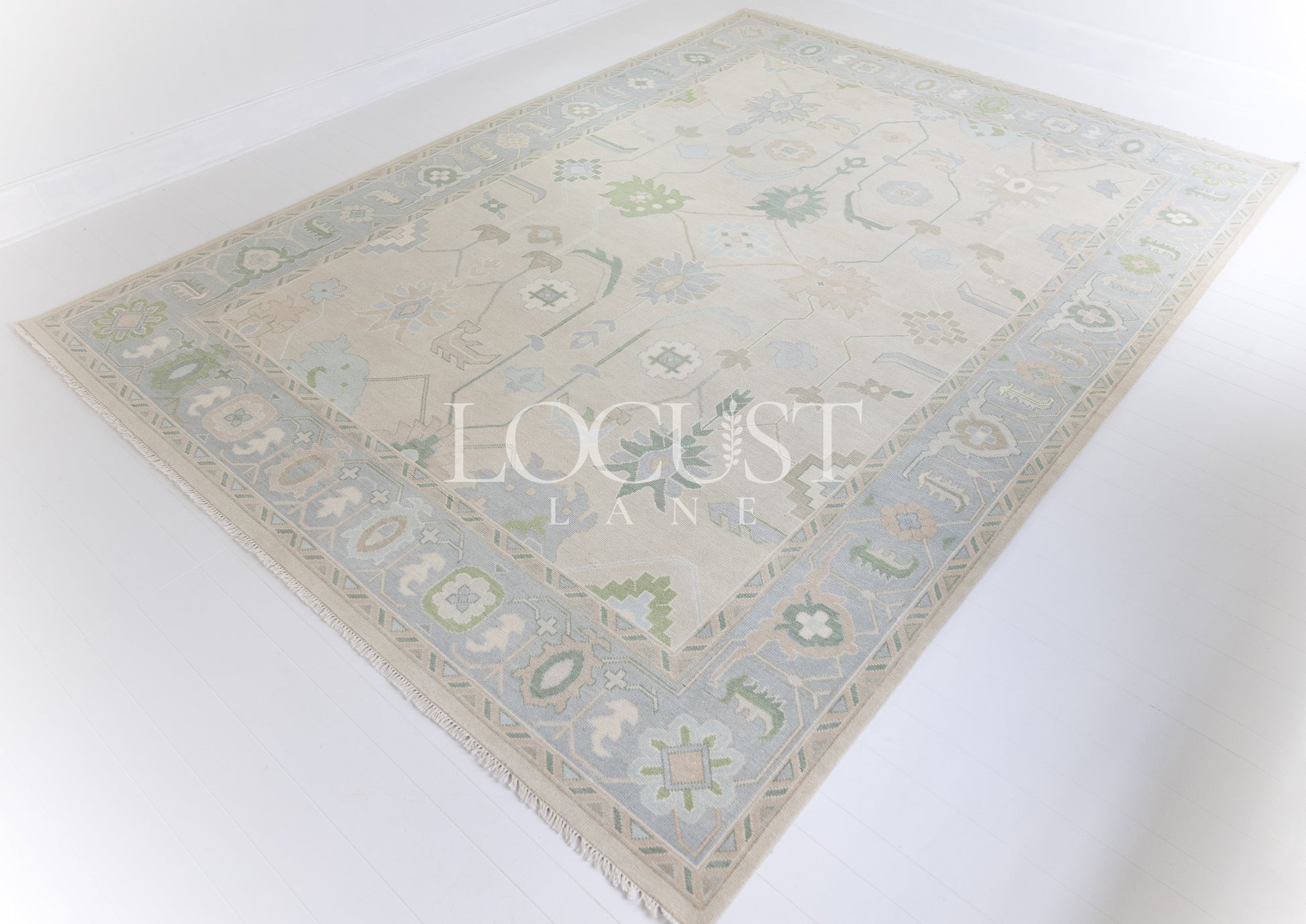 Fiona hand-knotted wool Oushak rug in ivory and faded blue from Locust Lane Rugs.