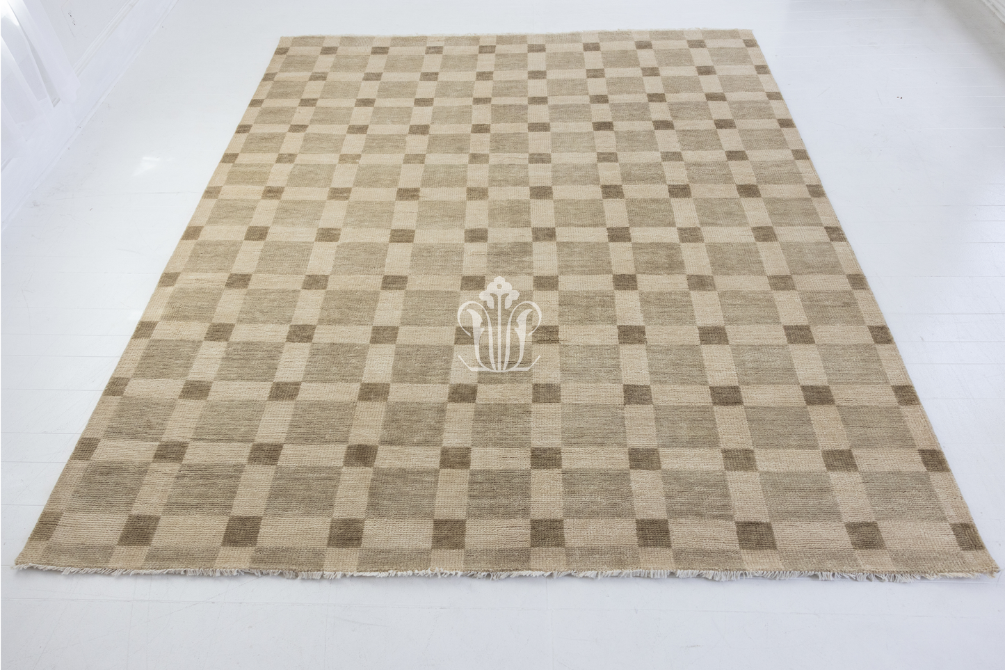 Checkered rug with a central logo on a white background