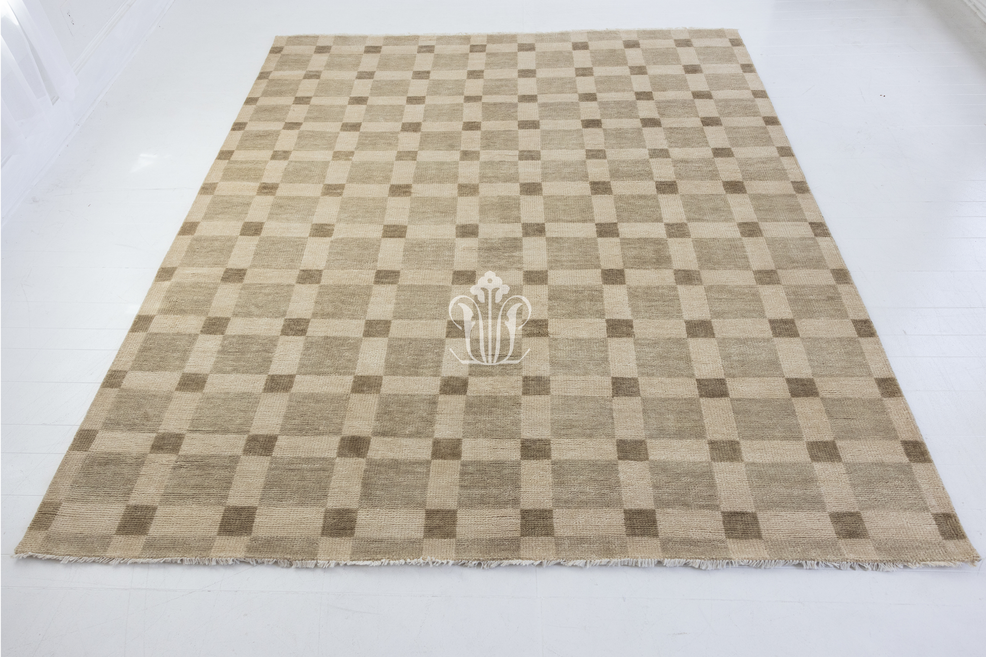Checkered rug with a central logo on a white background