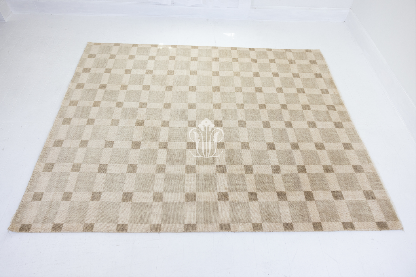 Checkered rug with a central logo on a white background