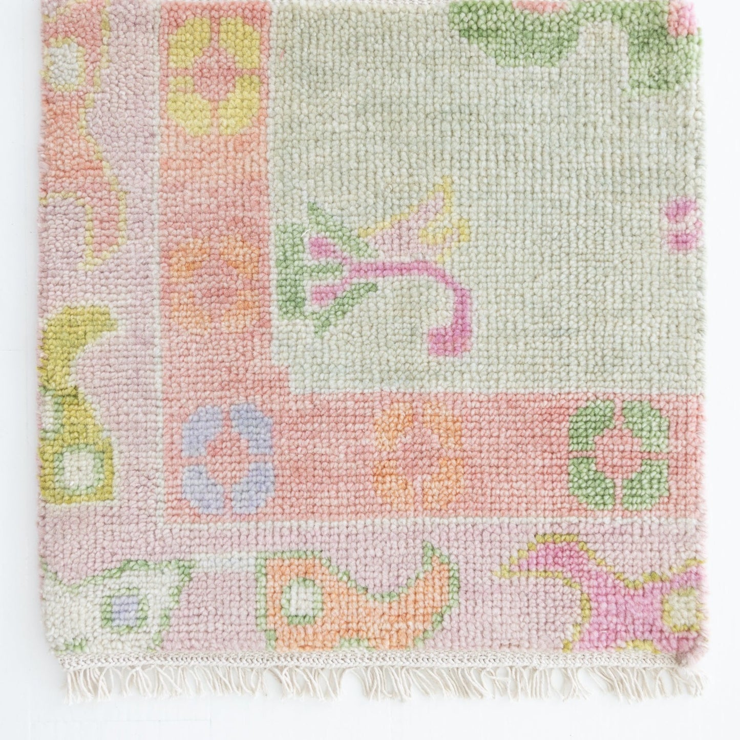 Handknotted wool rug sample in blush, lilac, sage, and citrus with floral and geometric motifs – Hill Rug Sample by Locust Lane Rugs