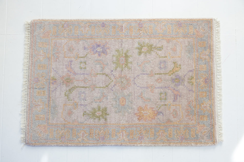 Hand-knotted wool rug with traditional Oushak design in soft blush, lavender, sage, and ivory – Rose Mini Rug by Locust Lane Rugs