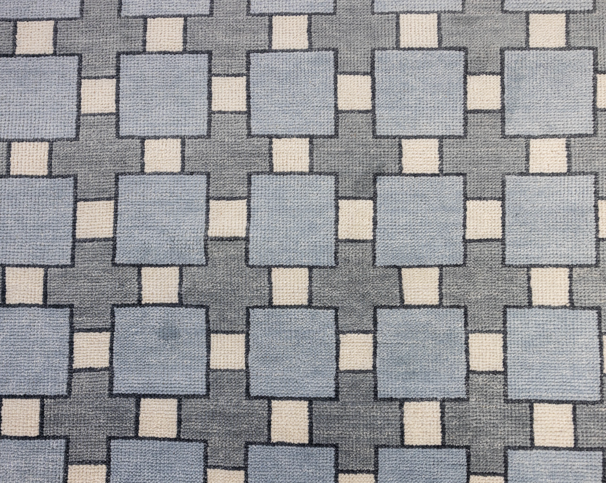Patterned fabric with blue and beige squares on a gray background