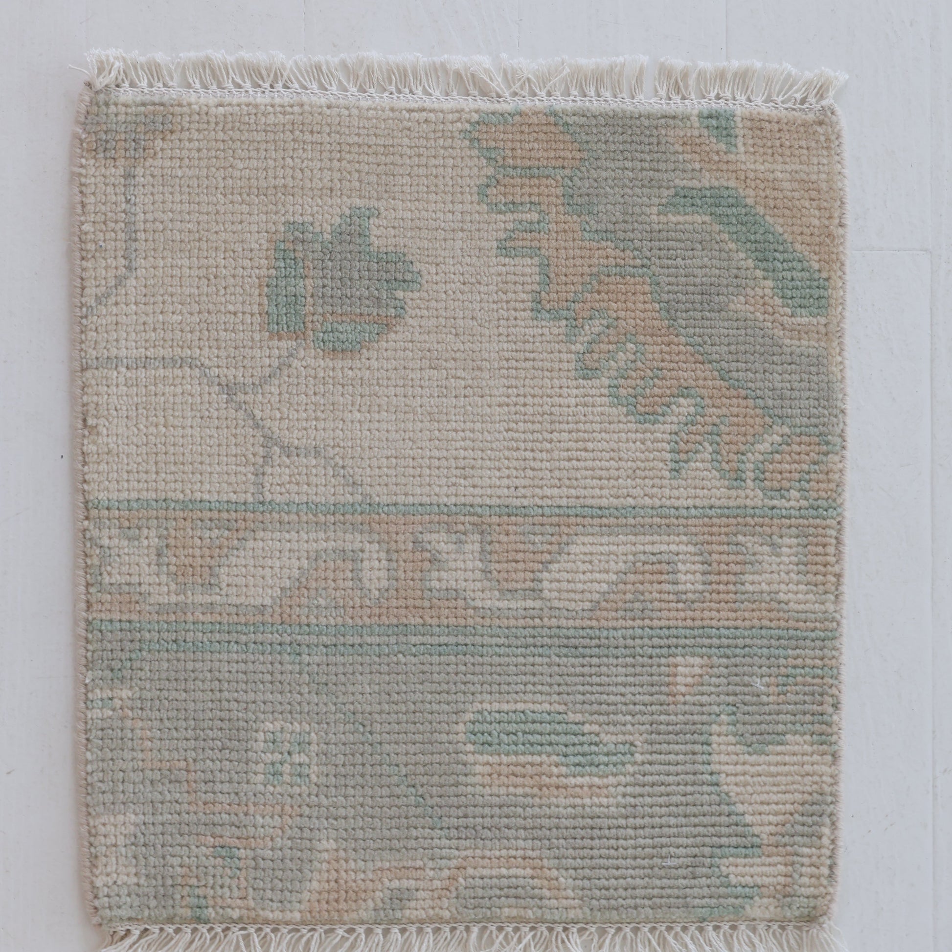Handknotted wool rug sample in seafoam green, sand, and cream floral design – Weezie Rug Sample by Locust Lane Rugs