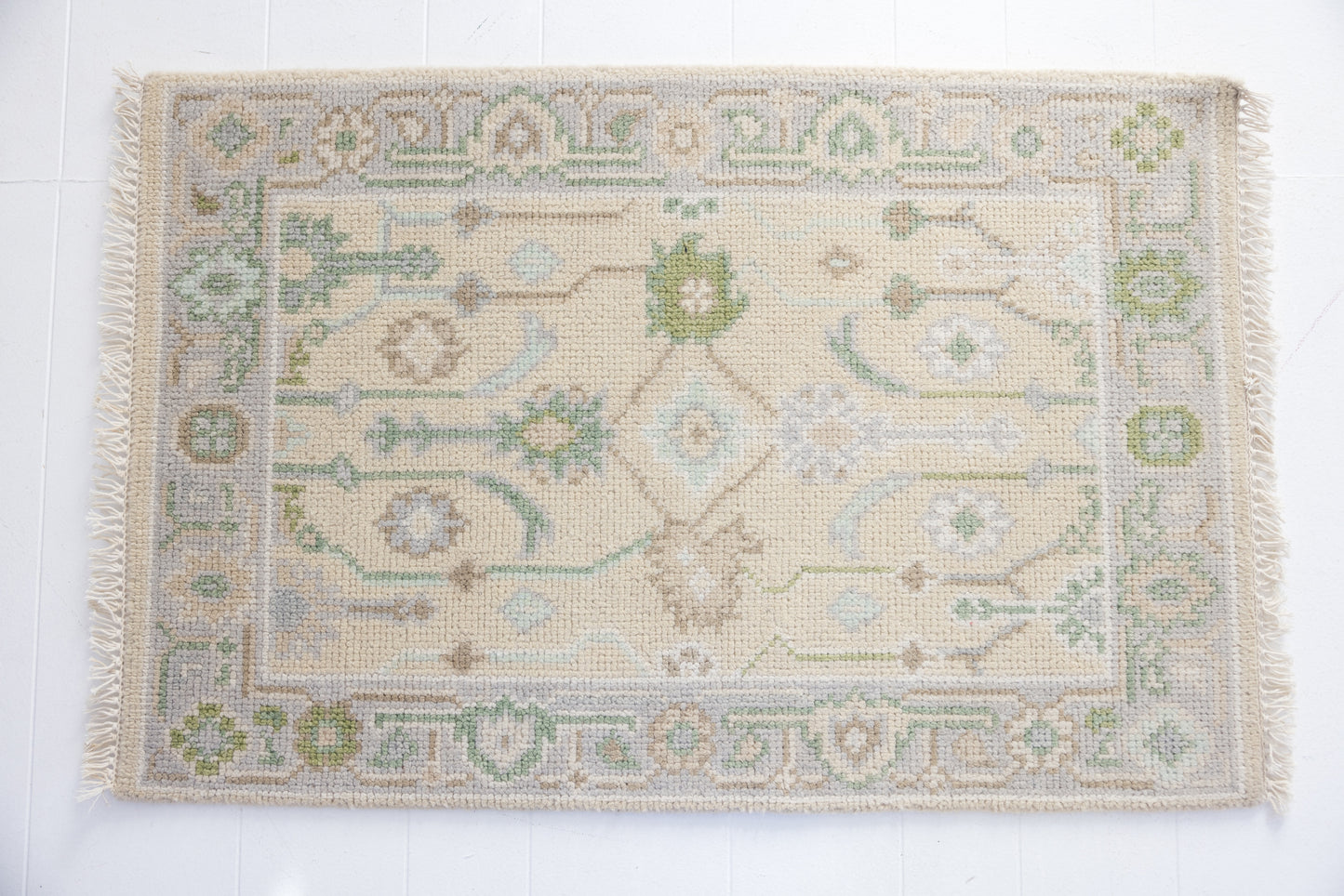 Hand-knotted wool rug with Oushak floral design in ivory, sage, and sky blue – Faye Mini Rug by Locust Lane Rugs