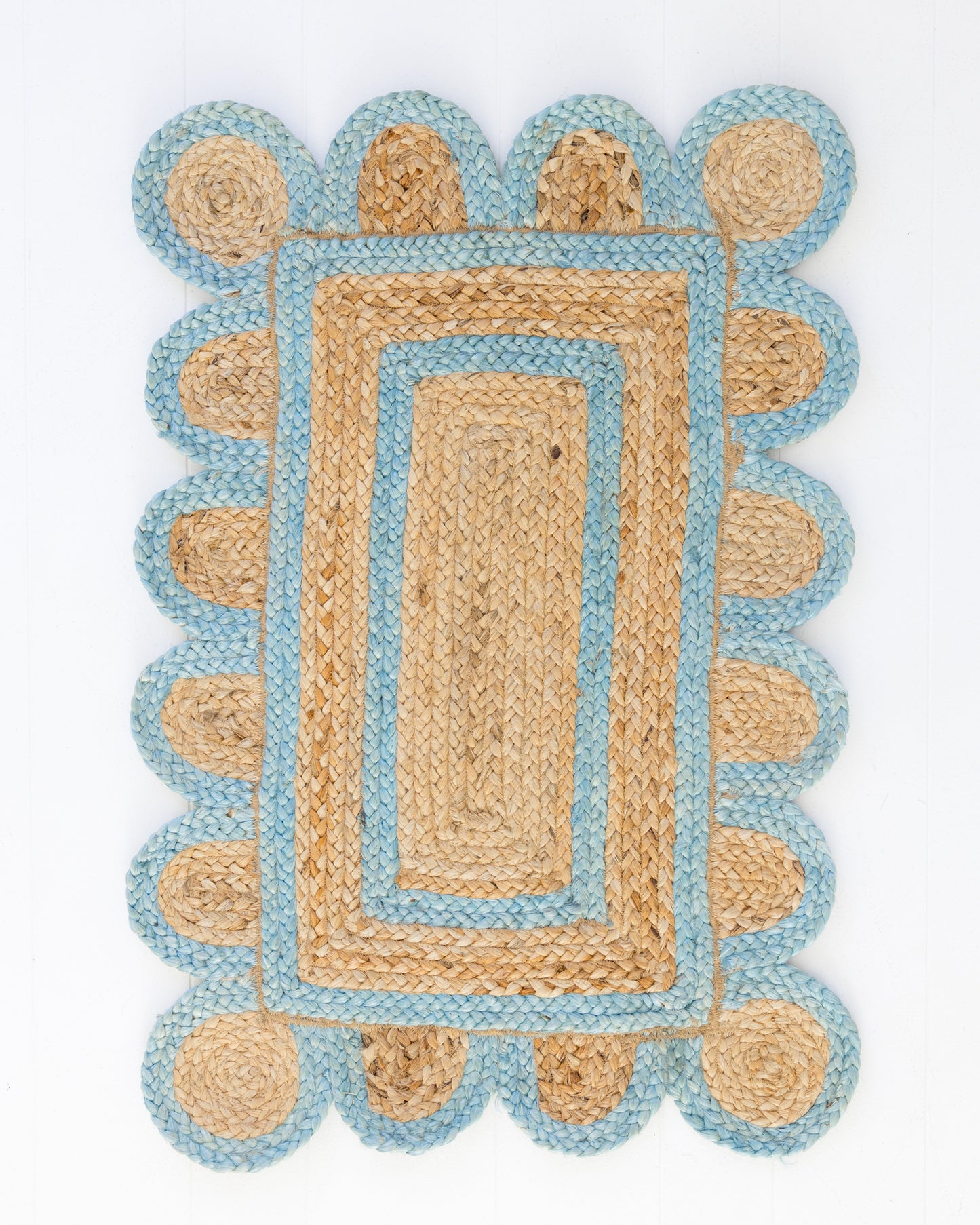 Handwoven 100% jute rug with natural field, frost blue scalloped edge, and protective cotton backing – Frost Blue Scalloped Edge Jute Rug by Locust Lane Rugs