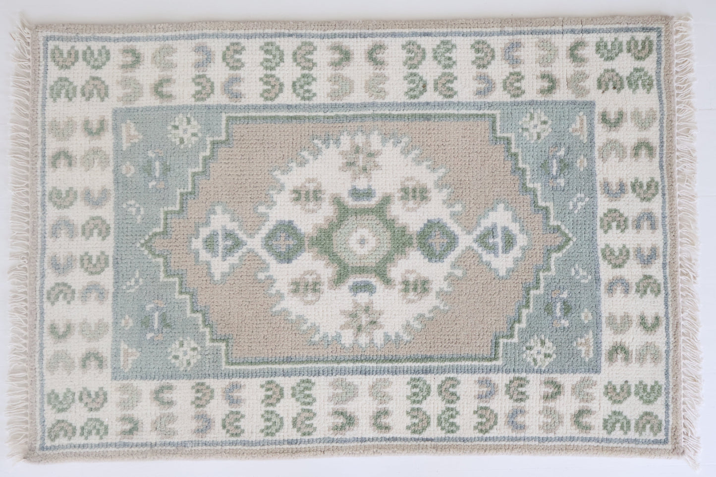 Hand-knotted wool rug with classic Oushak medallion in soft sage, sky blue, taupe, and ivory – Ivy Mini Rug by Locust Lane Rugs