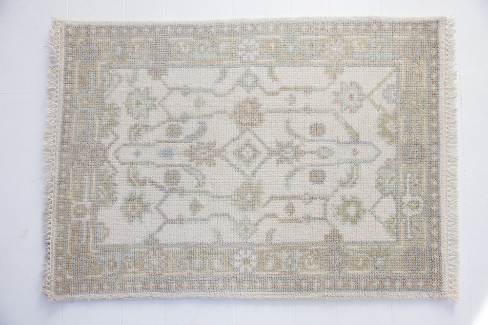 Hand-knotted wool rug with classic Oushak pattern in ivory, sky blue, and taupe – Pearl Mini Rug by Locust Lane Rugs