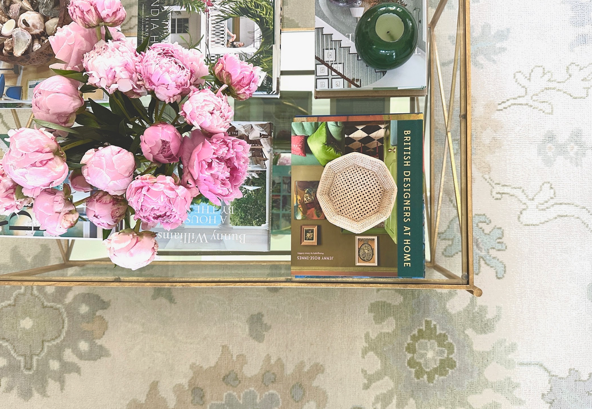 Close-up of a bestselling handcrafted Modern Oushak rug featuring soft sage green, blue, and ivory geometric border details.
