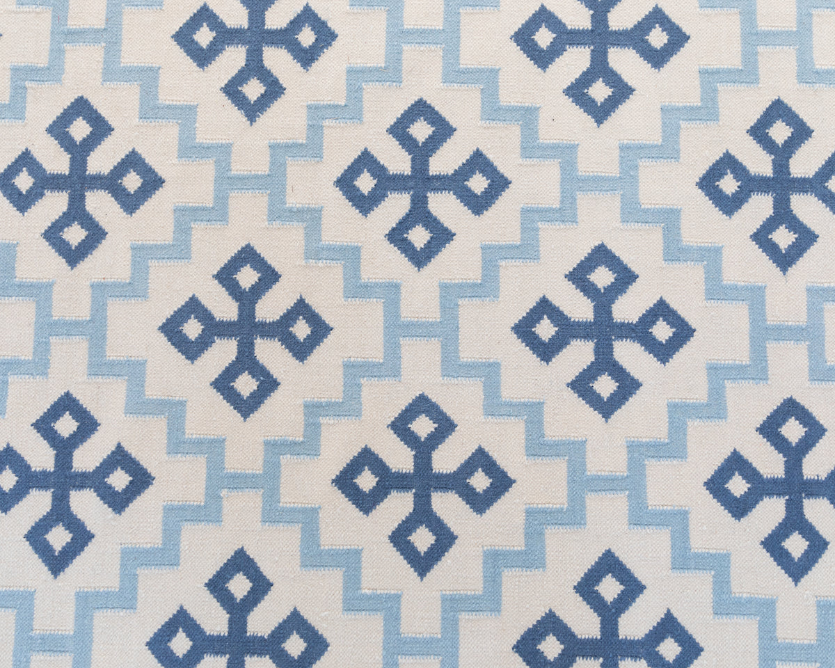 Denim Cross Flatweave Dhurrie Rug with blue geometric cross pattern on ivory wool