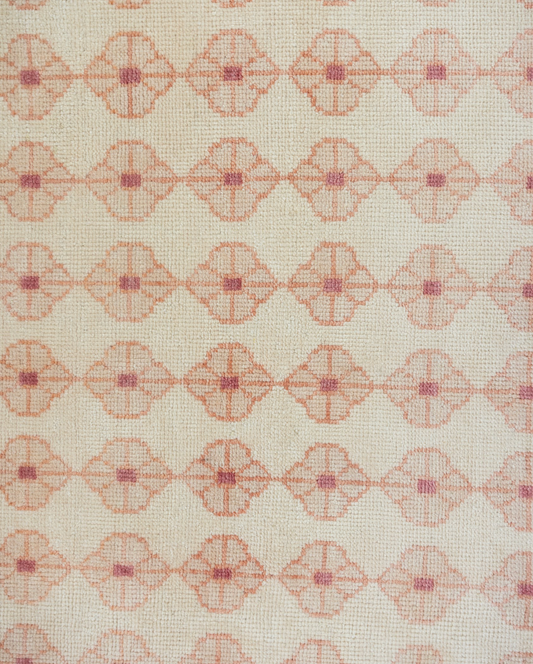 Patterned rug with geometric design on a beige background