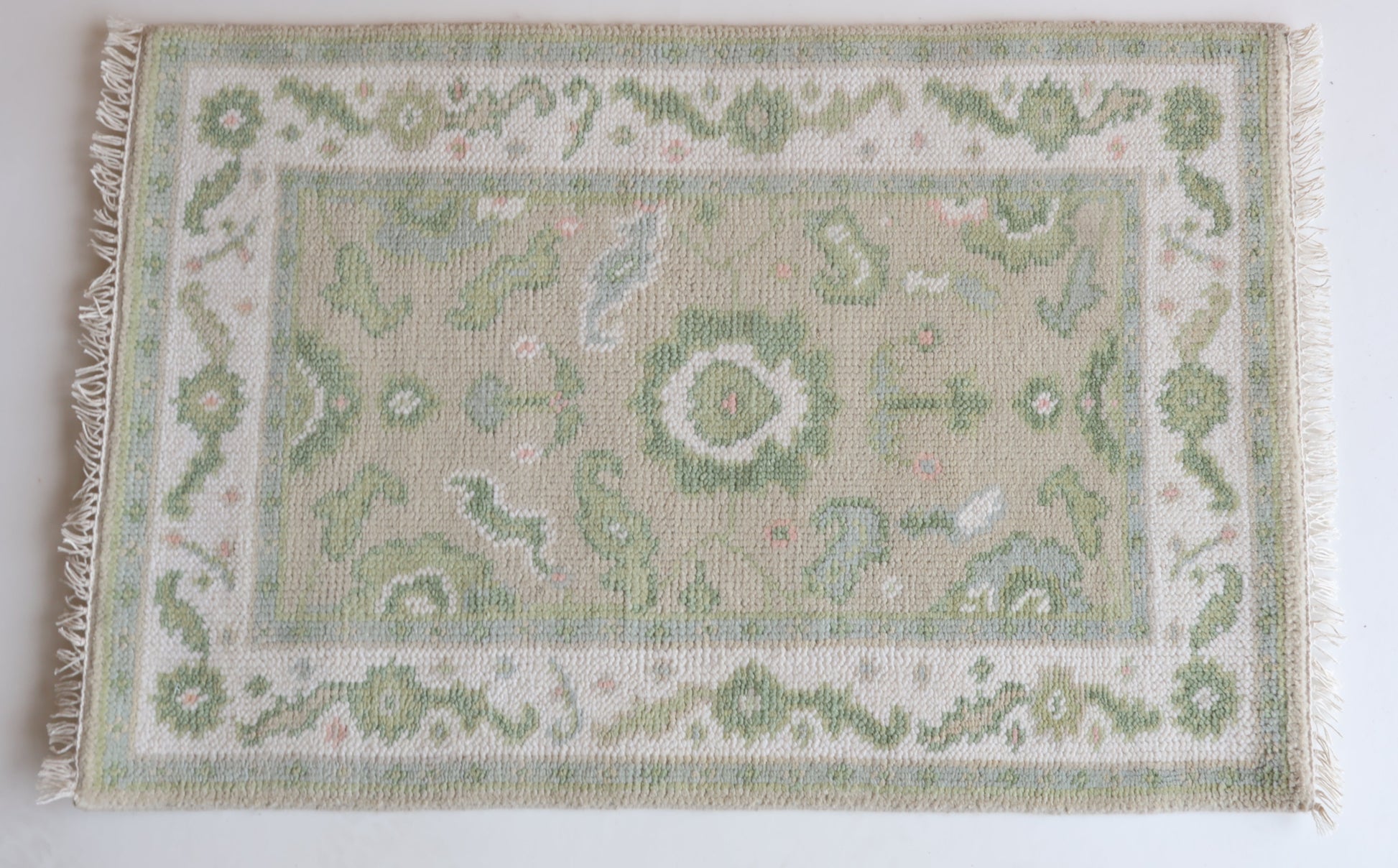Hand-knotted wool rug with classic Oushak floral design in soft green, ivory, and blush – Ellis Mini Rug by Locust Lane Rugs