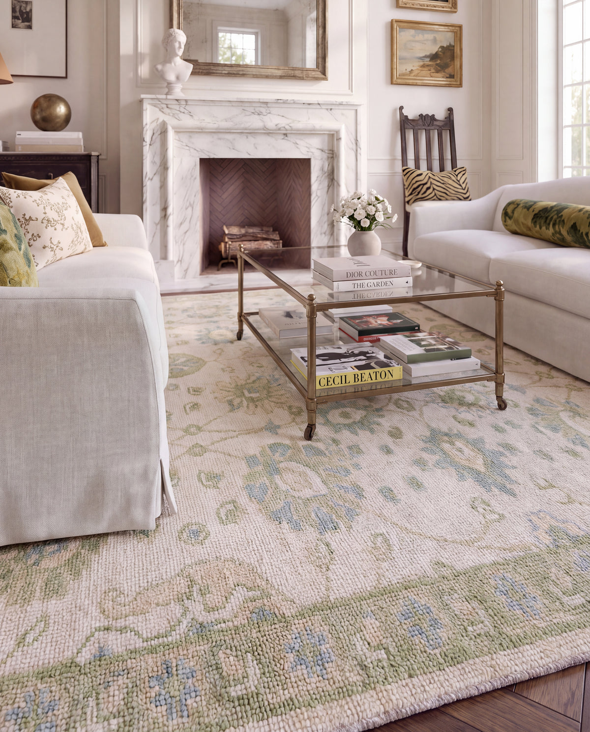 Essie floral wool Oushak rug in a cozy living room featuring soft blue and sage green botanical motifs.