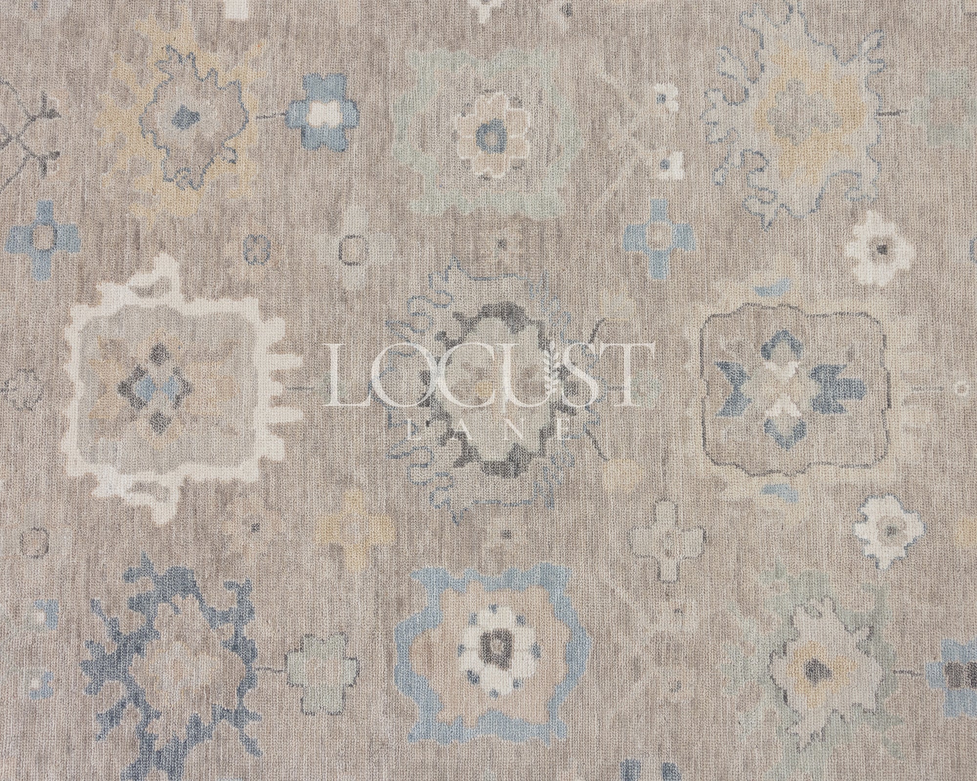 soft tones of beige, blue and grey hand knotted rug