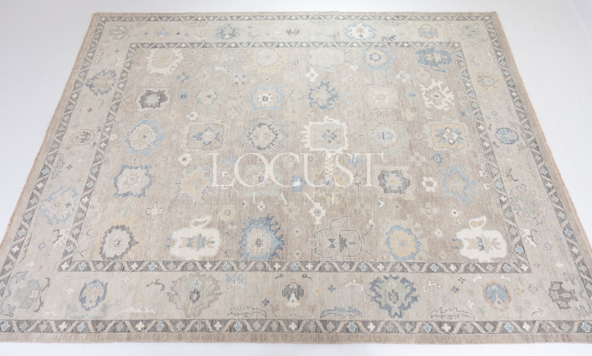 soft tones of beige, blue and grey hand knotted rug