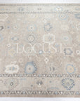 soft tones of beige, blue and grey hand knotted rug