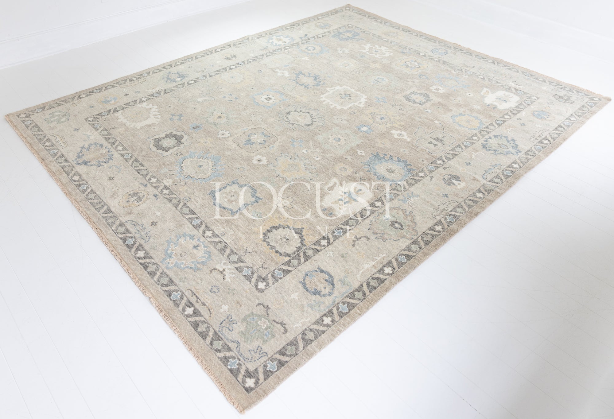 soft tones of beige, blue and grey hand knotted rug