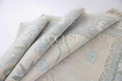 Fiona hand-knotted wool Oushak rug in ivory and faded blue from Locust Lane Rugs.