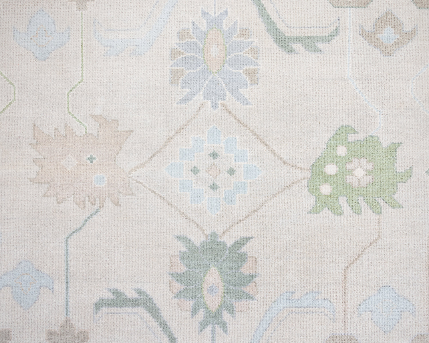 Fiona hand-knotted wool Oushak rug in ivory and faded blue from Locust Lane Rugs.