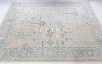 Fiona hand-knotted wool Oushak rug in ivory and faded blue from Locust Lane Rugs.