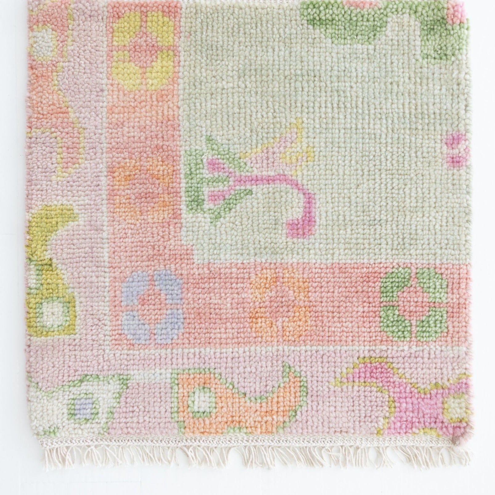 Handknotted wool rug sample in blush, lilac, sage, and citrus with floral and geometric motifs – Hill Rug Sample by Locust Lane Rugs