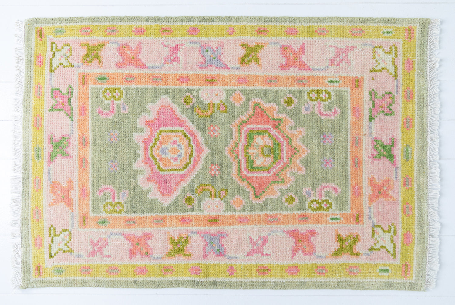 Hand-knotted wool rug with Oushak pattern in sage green, blush pink, and citron yellow – Hillside Mini Rug by Locust Lane Rugs