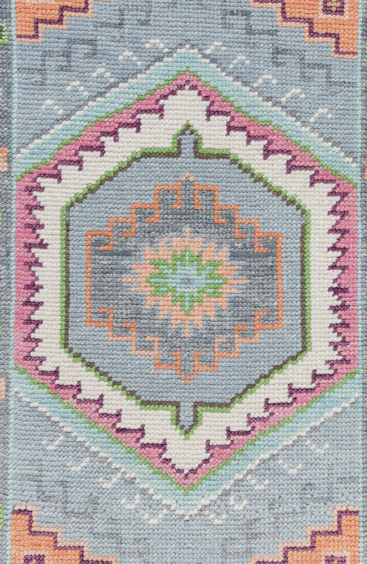Decorative rug with geometric pattern on a blue background