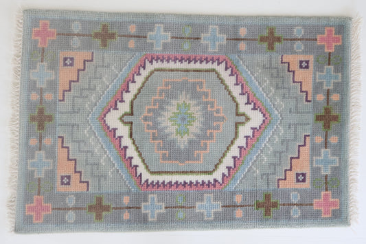 Hand-knotted wool rug featuring a geometric medallion design in soft sky blue, blush, olive, and lavender tones – Maisie Rug by Locust Lane Rugs