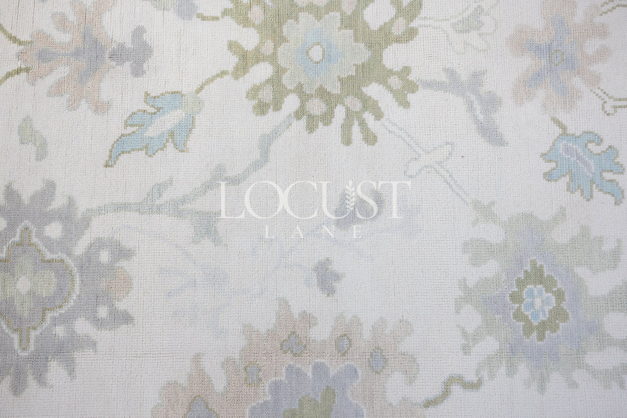 cream with blue and greens hand knotted rug