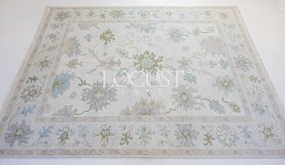 cream with blue and greens hand knotted rug