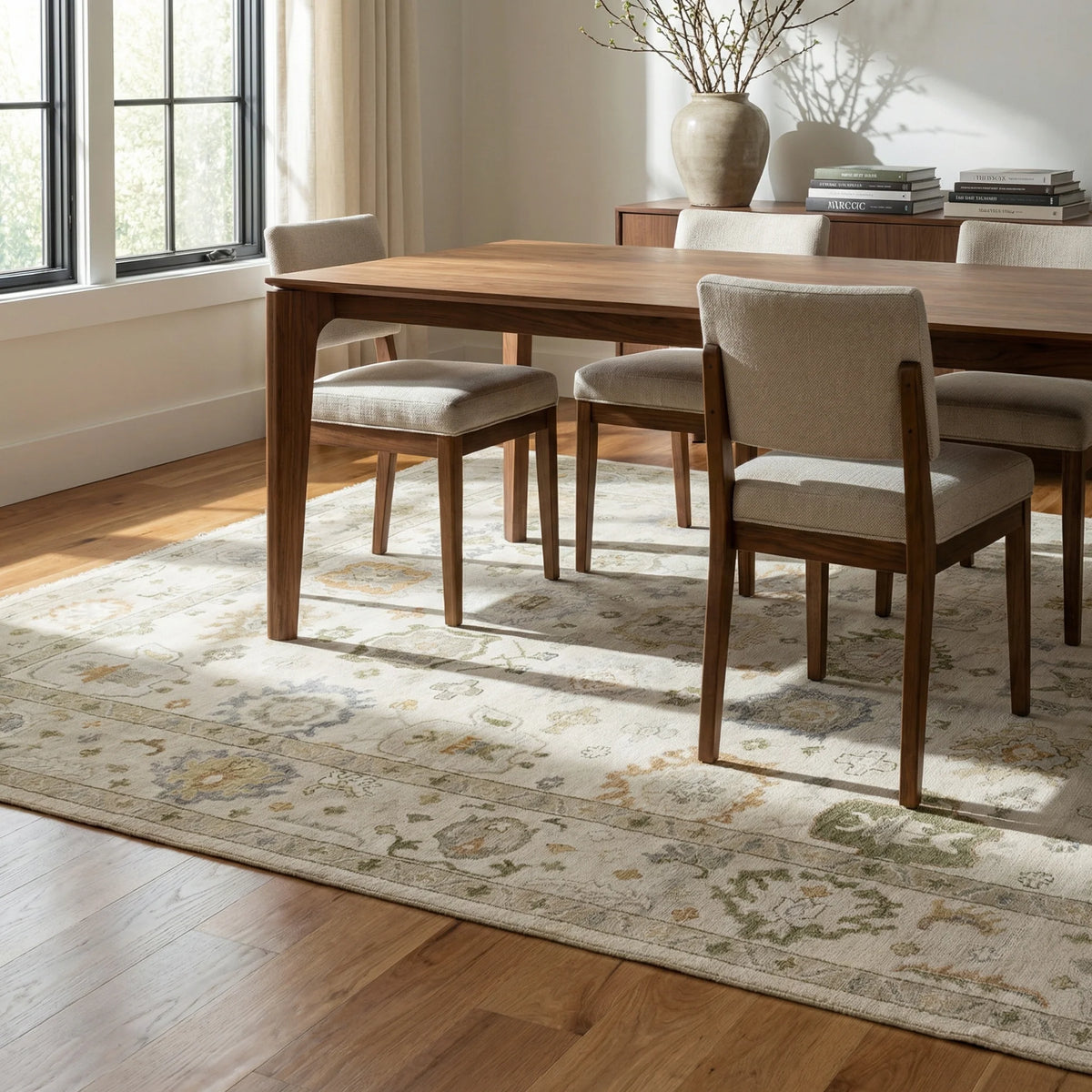 Patsy ivory and sage green Oushak rug styled beneath a dining table