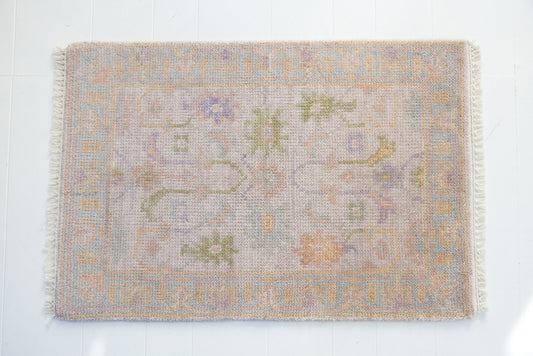 Hand-knotted wool rug with traditional Oushak design in soft blush, lavender, sage, and ivory – Rose Mini Rug by Locust Lane Rugs