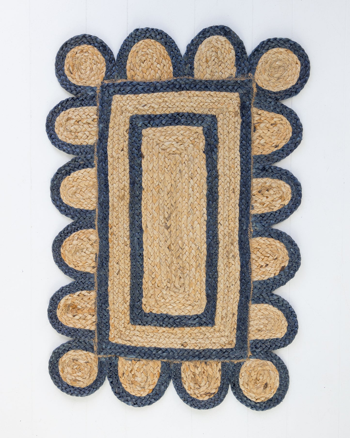 Handwoven 100% jute rug with natural field, navy scalloped edge, and protective cotton backing – Navy Scalloped Edge Jute Rug by Locust Lane Rugs