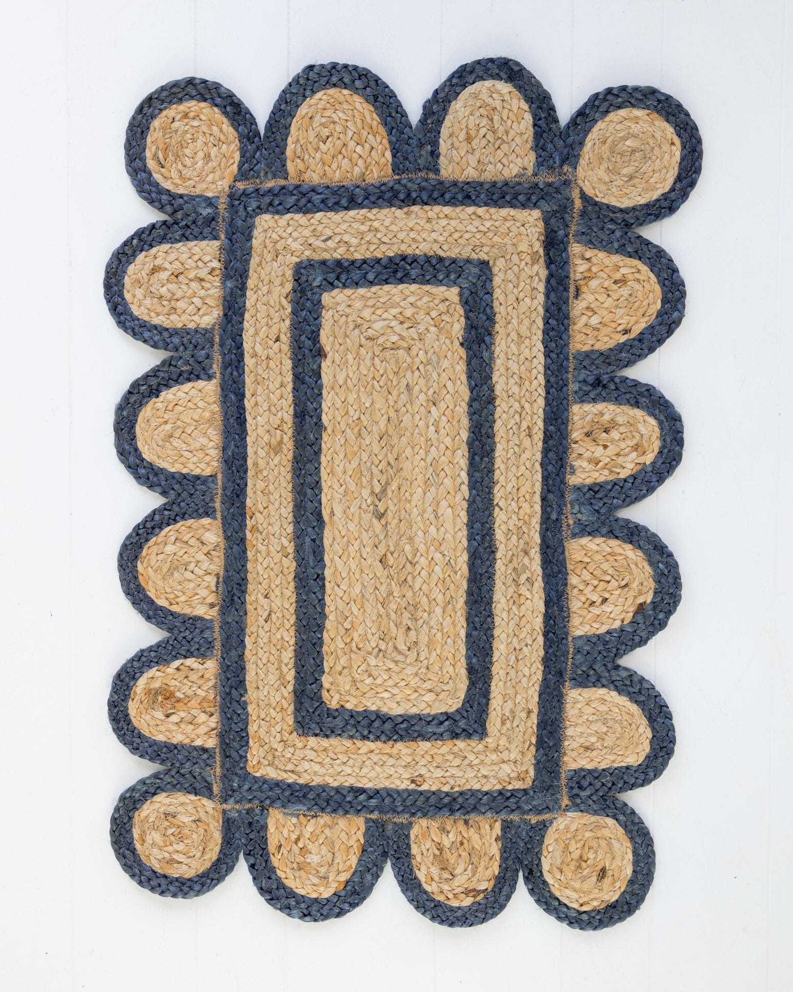 Handwoven 100% jute rug with natural field, navy scalloped edge, and protective cotton backing – Navy Scalloped Edge Jute Rug by Locust Lane Rugs