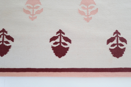 Flatweave rug with maroon and pink floral motifs and coordinating border, reversible construction — Cottage Floral Rug by Locust Lane Rugs
