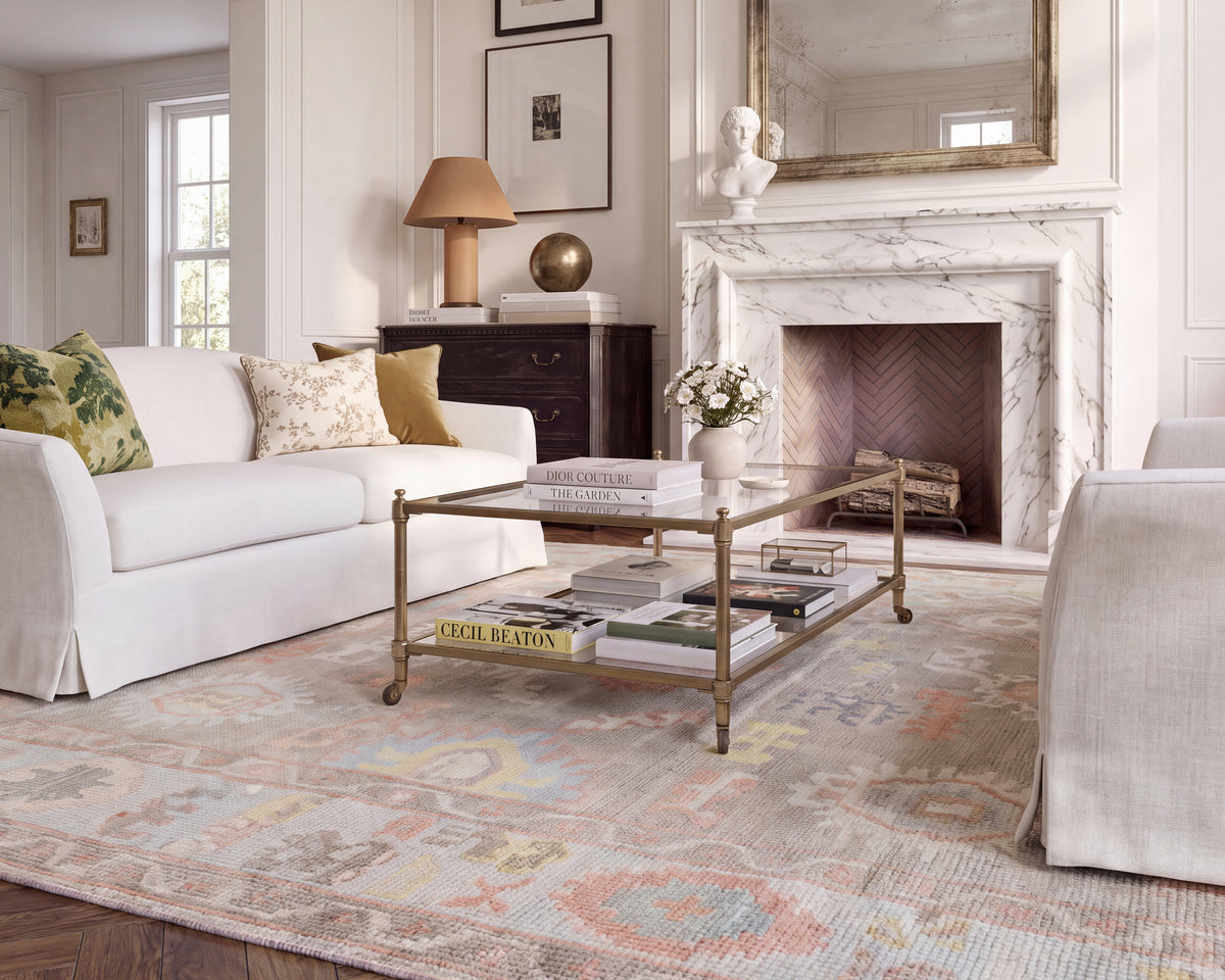 Sookie colorful floral Oushak area rug styled in a traditional living room with ivory sofas, a marble fireplace, and classic furnishings.