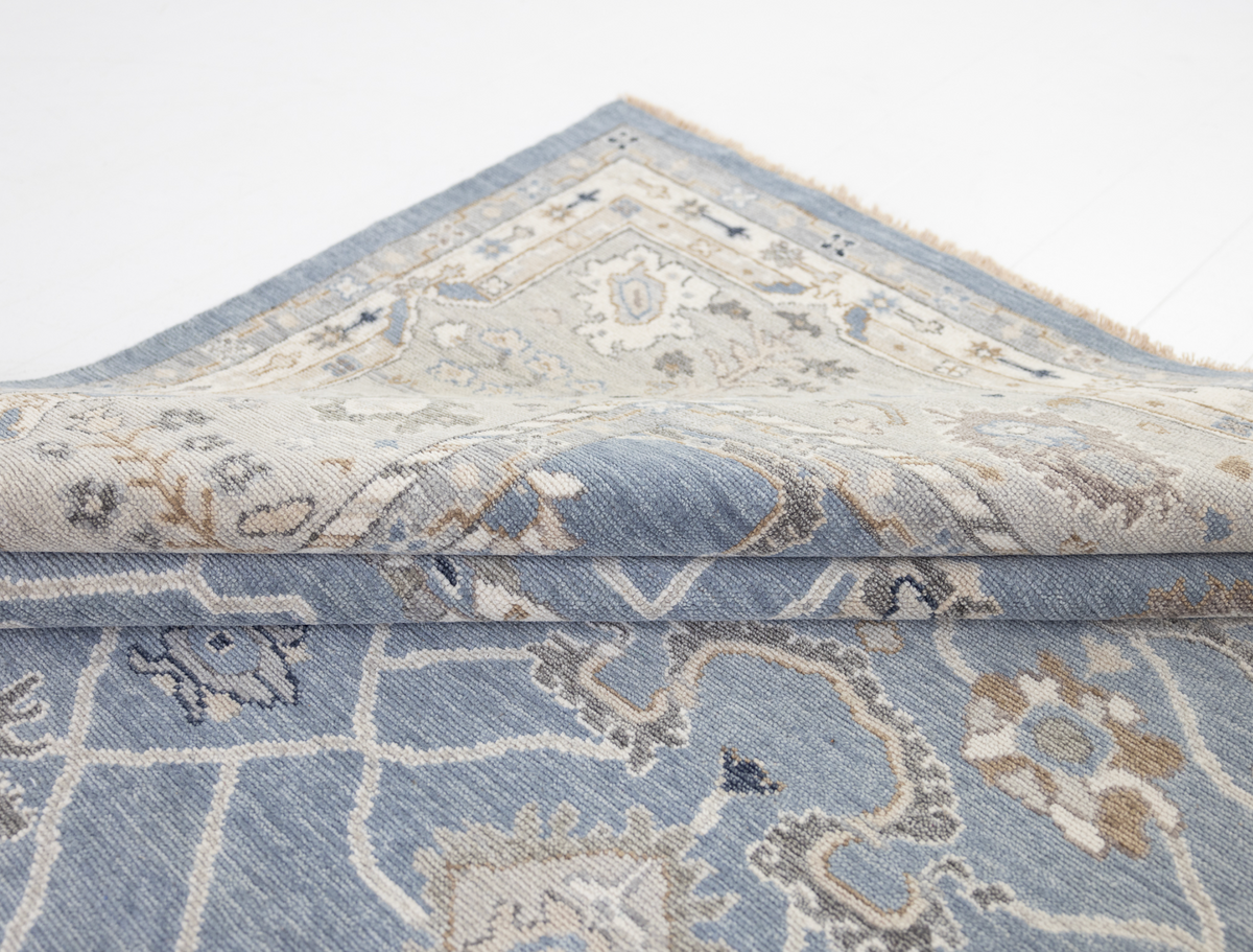 Trudie Collector's Edition Oushak rug featuring an ornate ivory and blue border