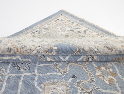 Trudie Collector's Edition Oushak rug featuring an ornate ivory and blue border