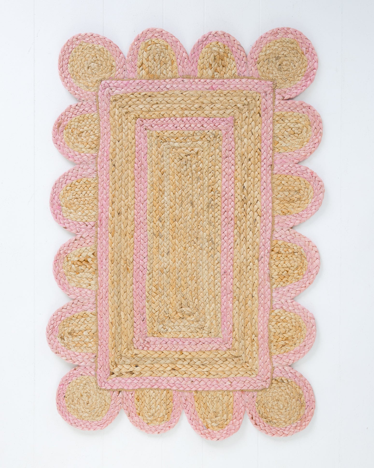Handwoven 100% jute rug with natural field, bright pink scalloped edge, and protective cotton backing – Bright Pink Scalloped Edge Jute Rug by Locust Lane Rugs