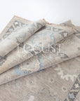 soft tones of beige, blue and grey hand knotted rug