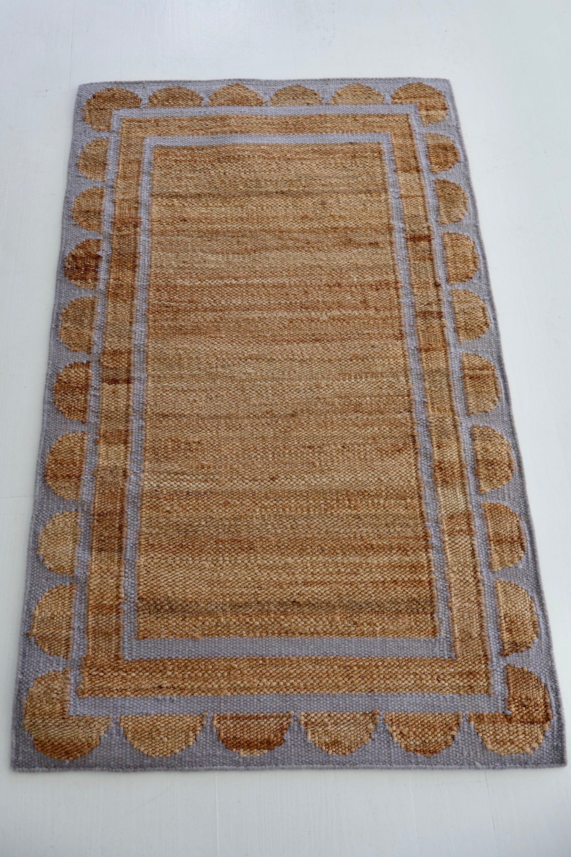 Jute and wool rug with lilac scalloped edge, handwoven for natural elegance by Locust Lane Rugs.
