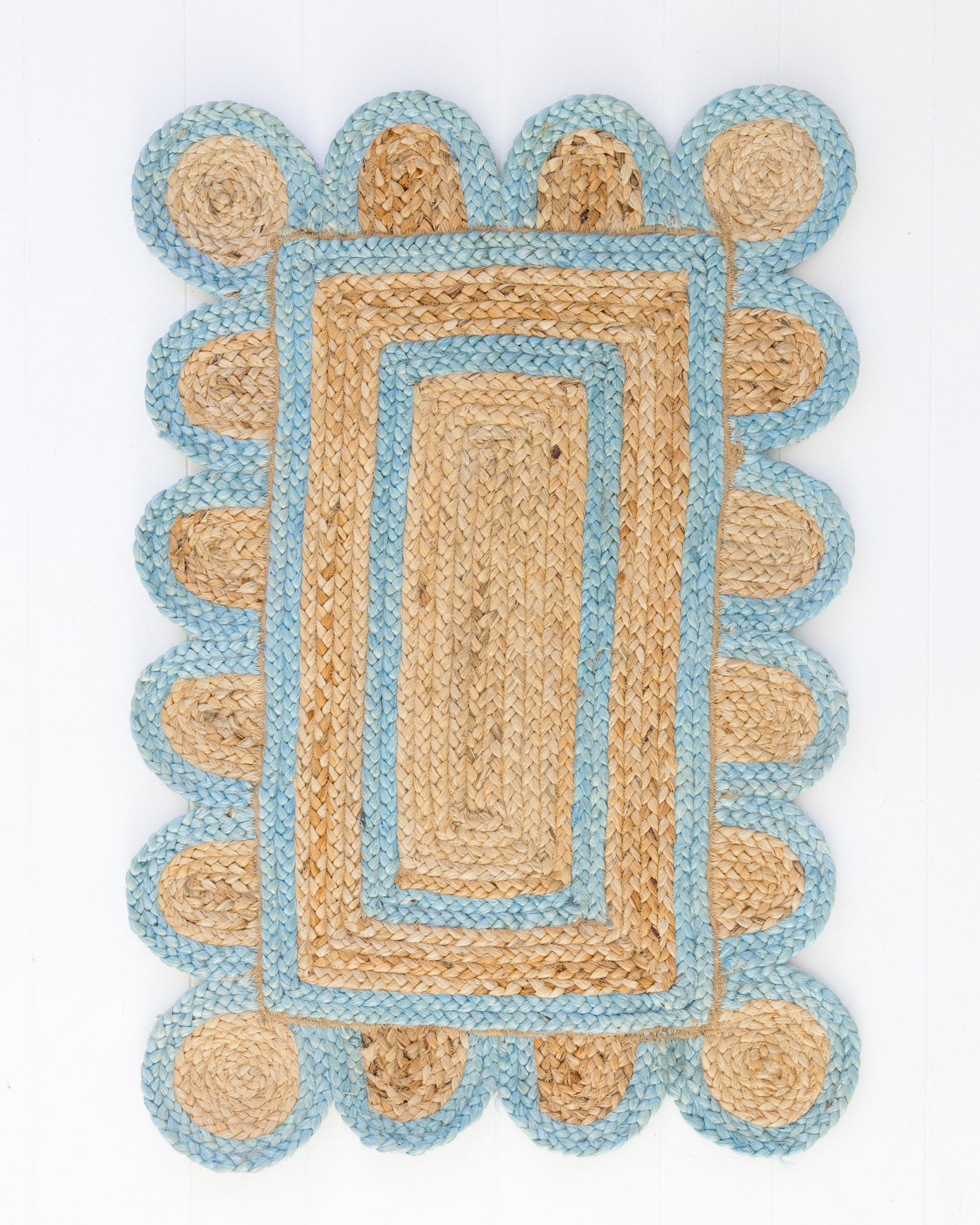 Handwoven 100% jute rug with natural field, frost blue scalloped edge, and protective cotton backing – Frost Blue Scalloped Edge Jute Rug by Locust Lane Rugs