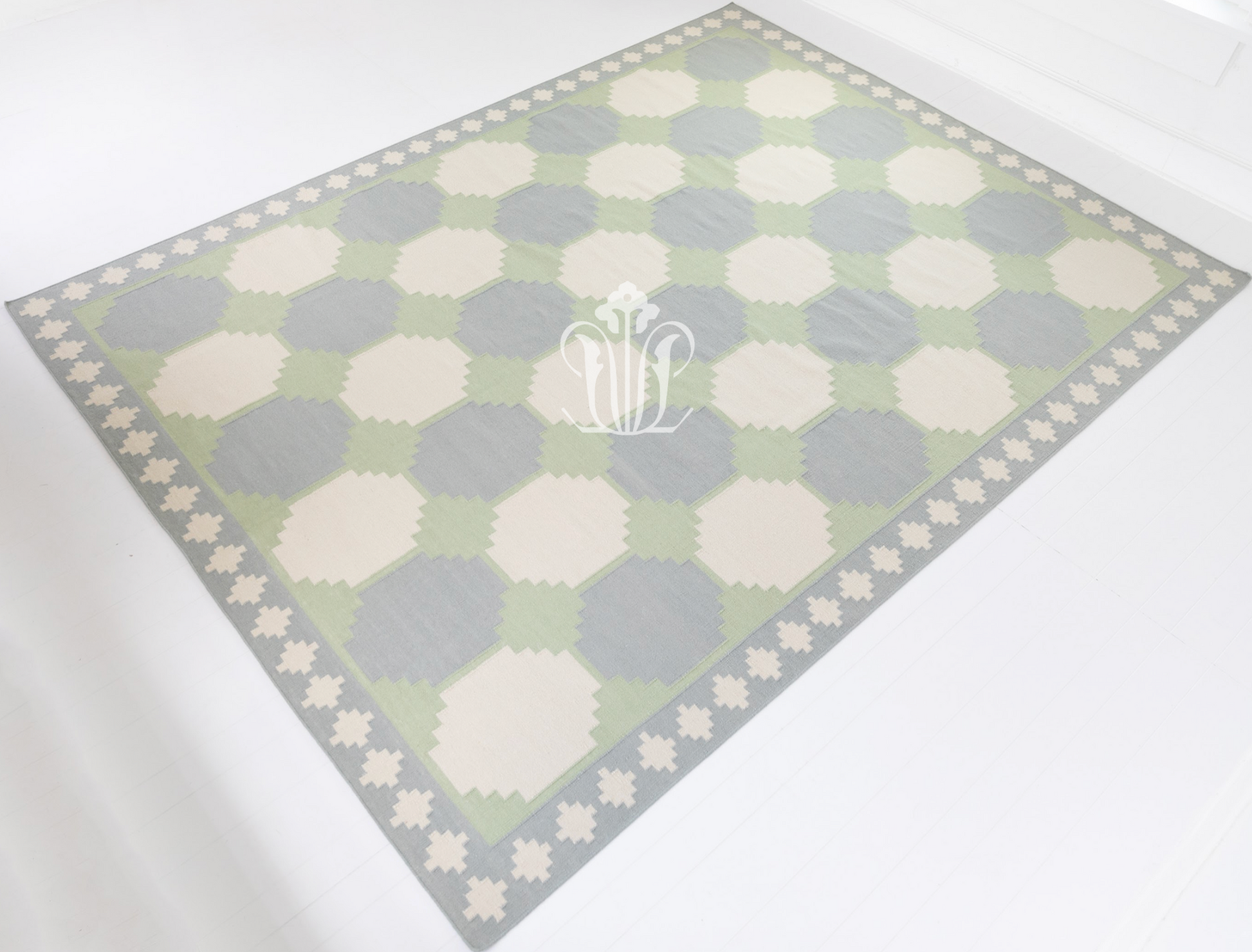 Full view of the Geometric Flatweave Rug showcasing its oversized geometric design and decorative border.