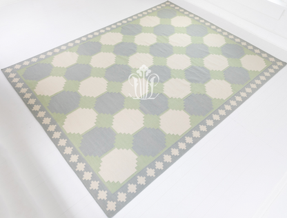 Full view of the Geometric Flatweave Rug showcasing its oversized geometric design and decorative border.