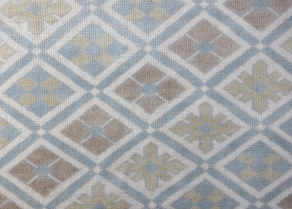 Milly hand-knotted wool Modern Oushak rug featuring a geometric diamond pattern in powder blue, sage green, taupe, and ivory.