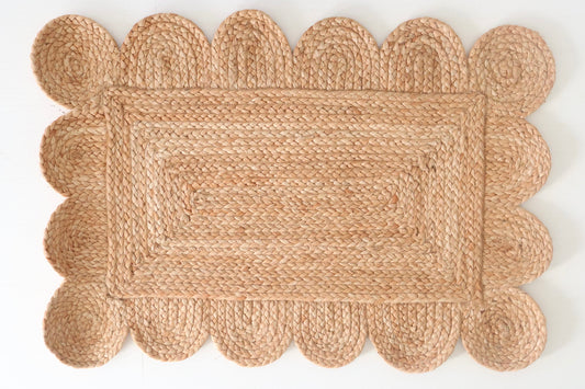 Natural scalloped jute mini rug with hand-braided rectangular weave and protective backing by Locust Lane Rugs