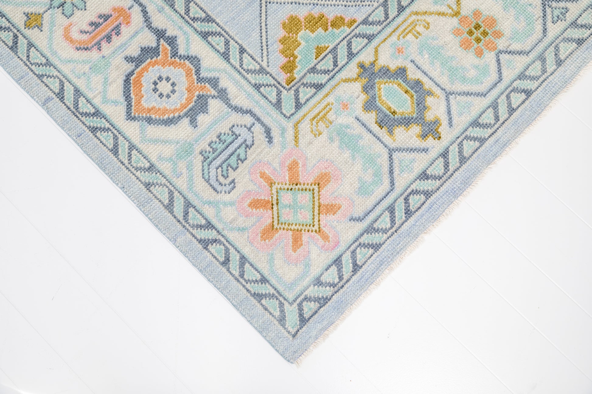 Corner detail of the Odette hand-knotted modern Oushak wool rug